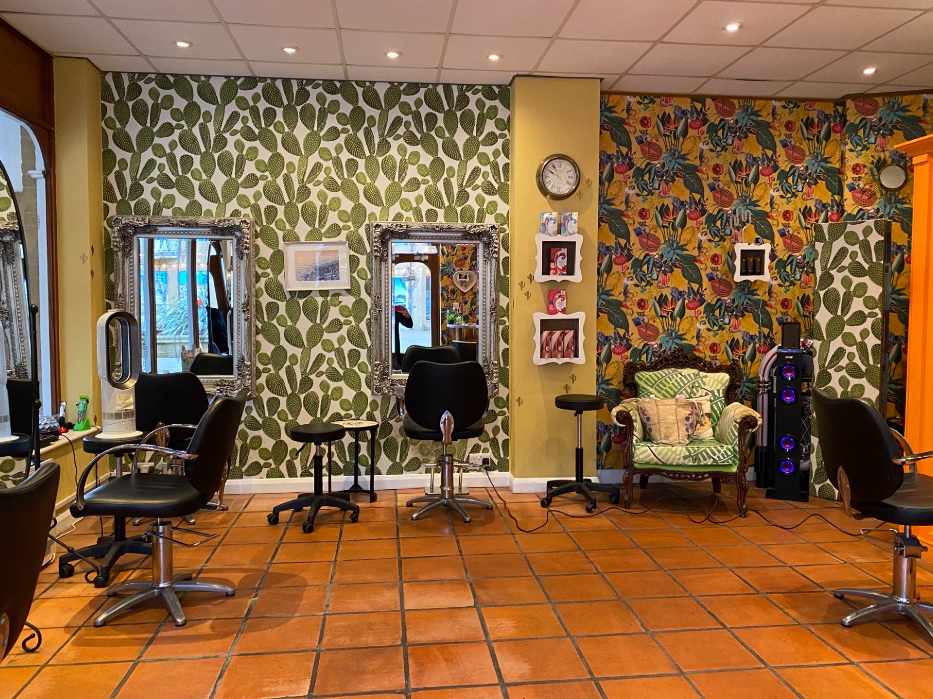 Hair Brighton salon interior with tropical wallpaper and styling stations