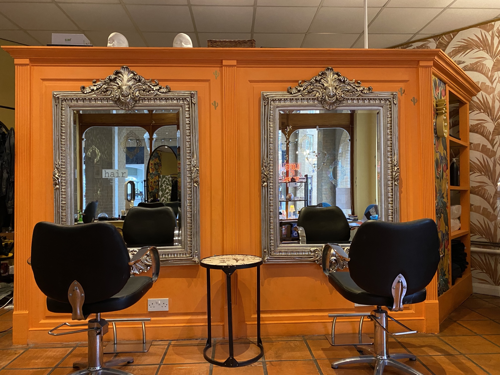 Hair Brighton orange styling wall with ornate mirrors and salon chairs